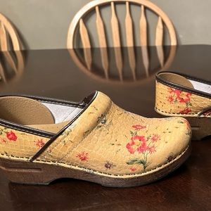 Dansko clogs. Tan with floral print, dark brown heel.